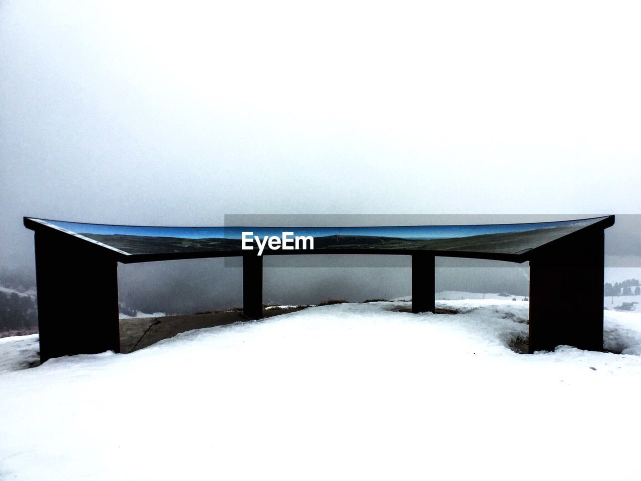 Built structure on snow covered field against sky