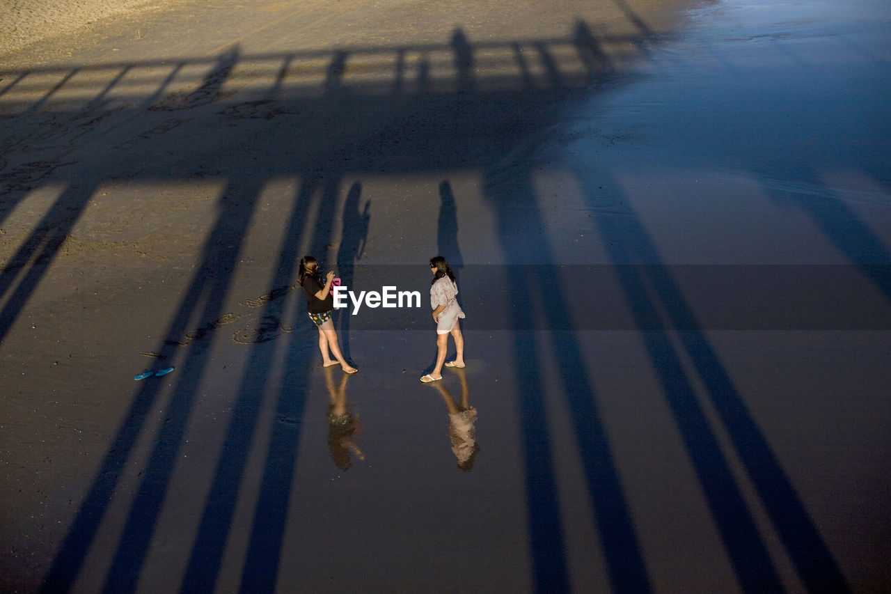 HIGH ANGLE VIEW OF MEN ON SHADOW