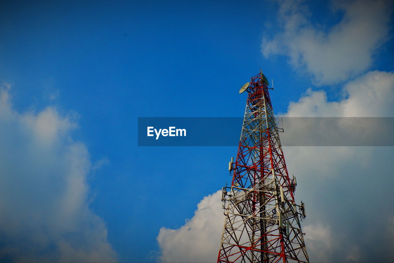 Low angle view of communications tower against blue sky