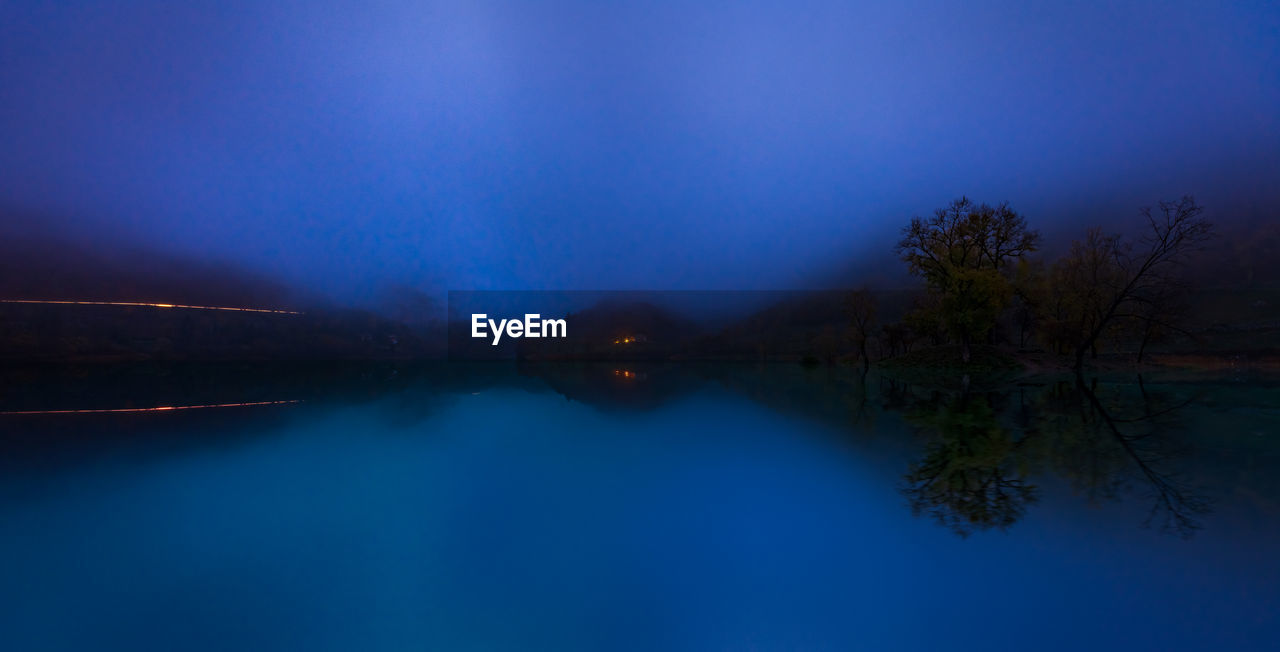 SCENIC VIEW OF LAKE AGAINST BLUE SKY