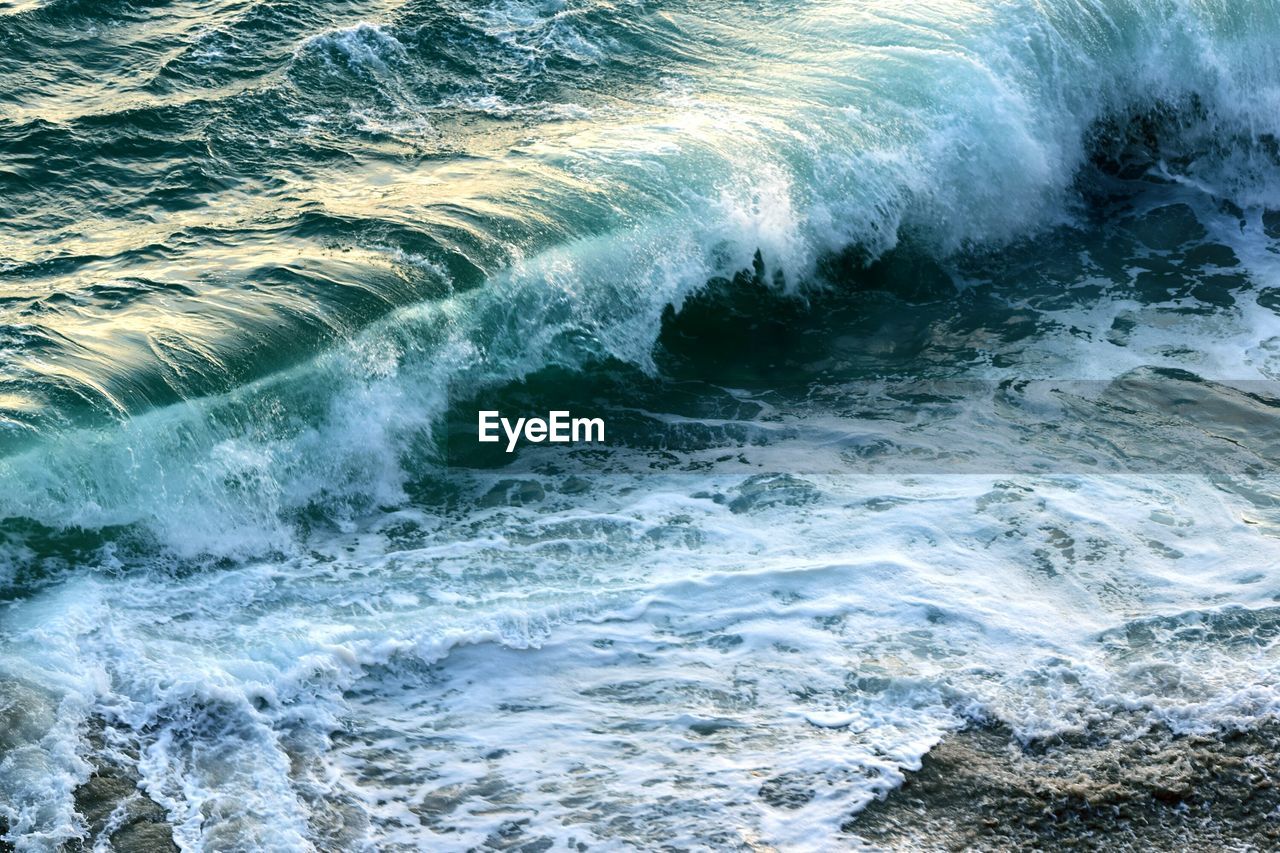 Close-up of waves splashing on beach