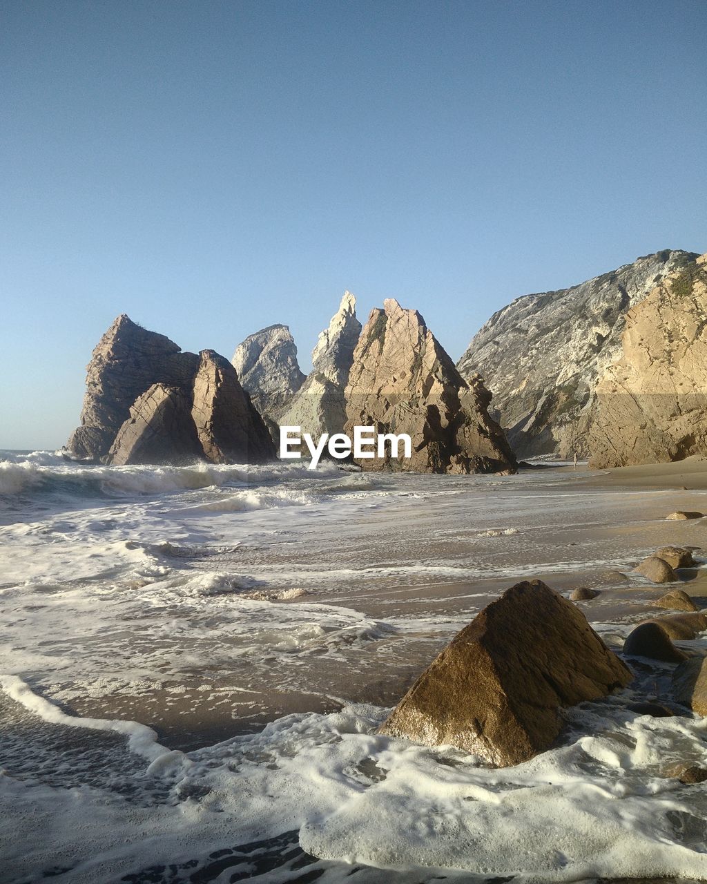 Scenic view of rock formations on beach