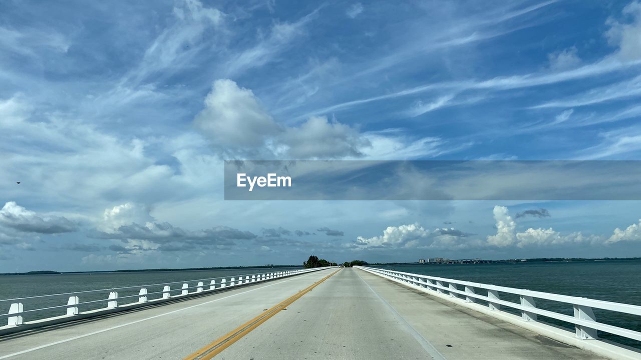 Road by sea against sky