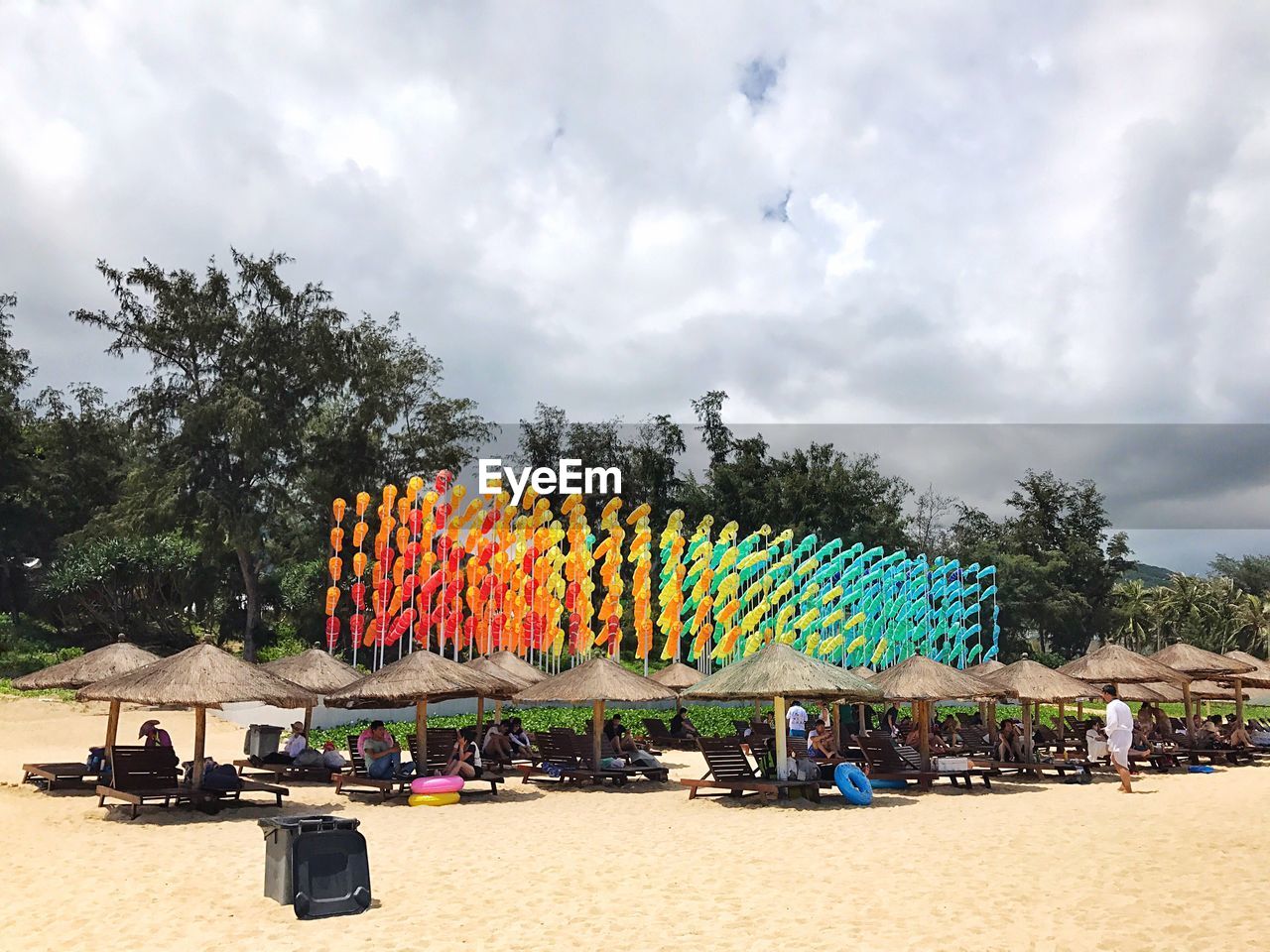 MULTI COLORED BEACH UMBRELLAS AGAINST SKY