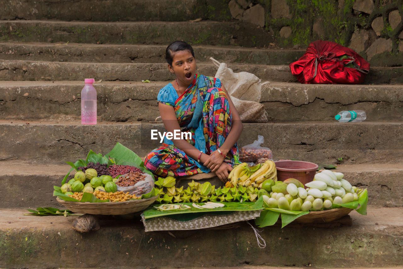 PERSON EATING FOOD IN BASKET