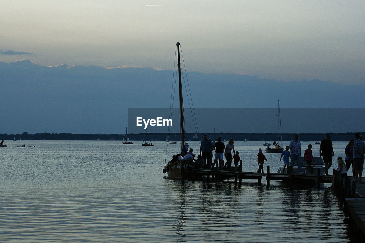 water, sea, nautical vessel, sky, transportation, boat, nature, bay, mode of transportation, group of people, vehicle, ocean, beauty in nature, shore, travel, boating, body of water, horizon, dock, scenics - nature, ship, coast, dusk, watercraft, sailboat, morning, vacation, men, large group of people, travel destinations, trip, holiday, tranquility, outdoors, beach, land, waterfront, lifestyles, tourism, crowd, pier, mountain, tranquil scene, day, silhouette, sailing, leisure activity, reflection, idyllic, harbor, cloud, environment, marina, wave