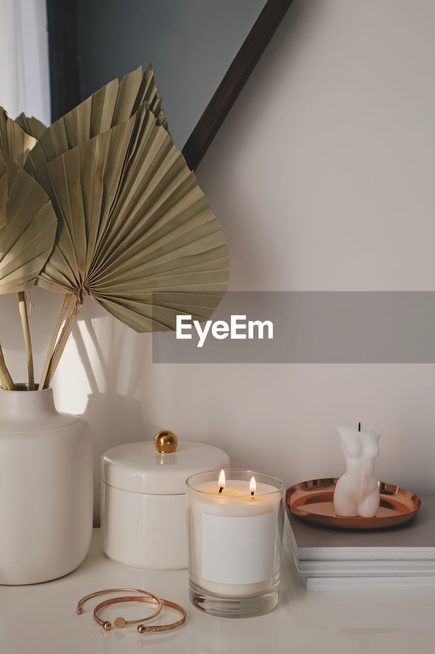 Modern trendy interior details. burning candle, home decor, feminine accessories