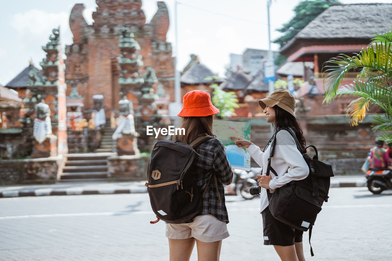 rear view of woman walking on street in city