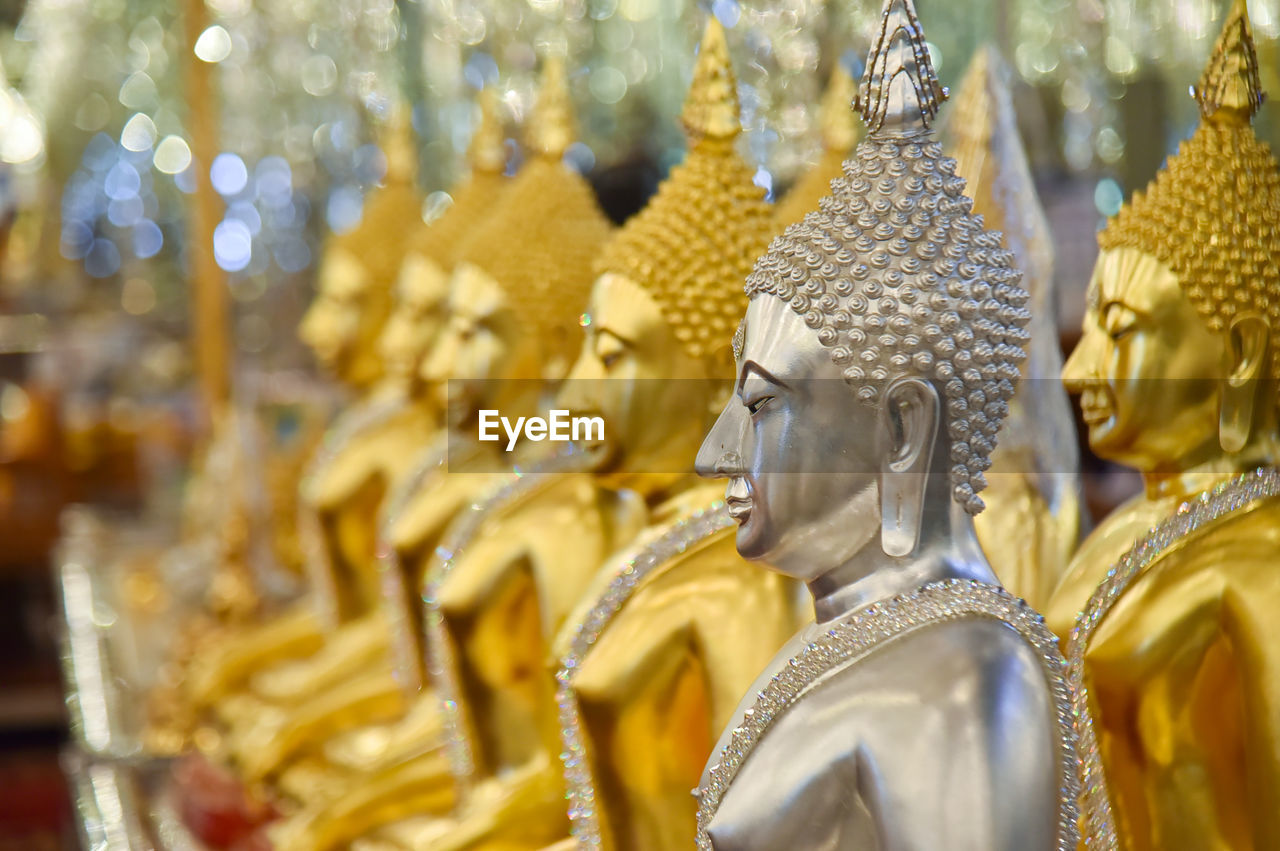 Close-up of buddha statues in temple