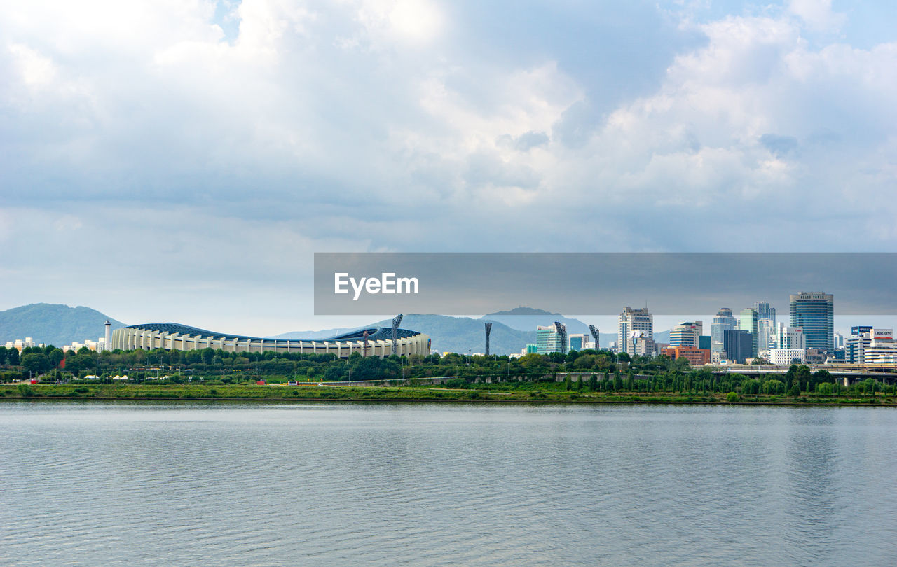 SCENIC VIEW OF LAKE AGAINST BUILDINGS IN CITY