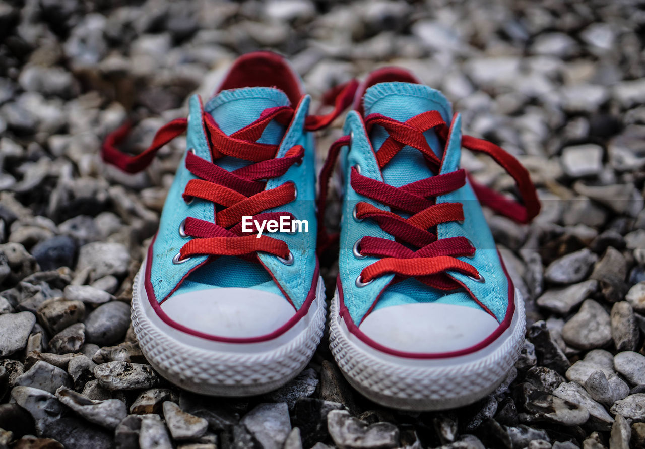 Close-up of baby boots on stones