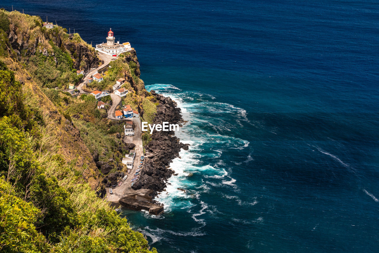 The fantastic view of the lighthouse from nordeste on the steep coast of azores island of sao miguel