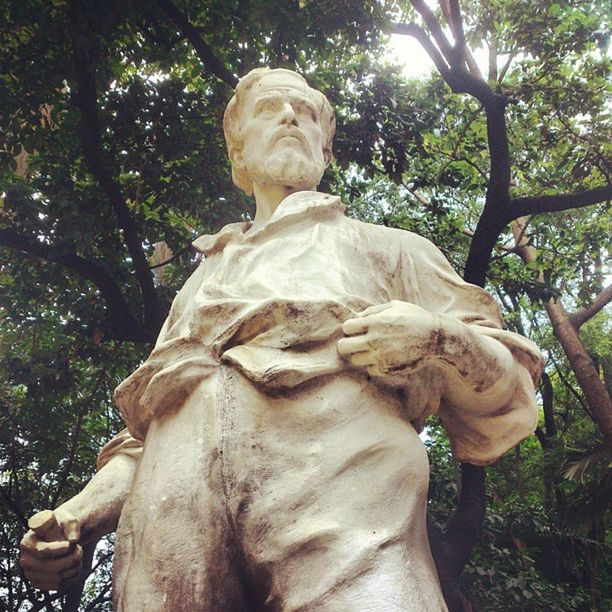 LOW ANGLE VIEW OF STATUE AGAINST TREES