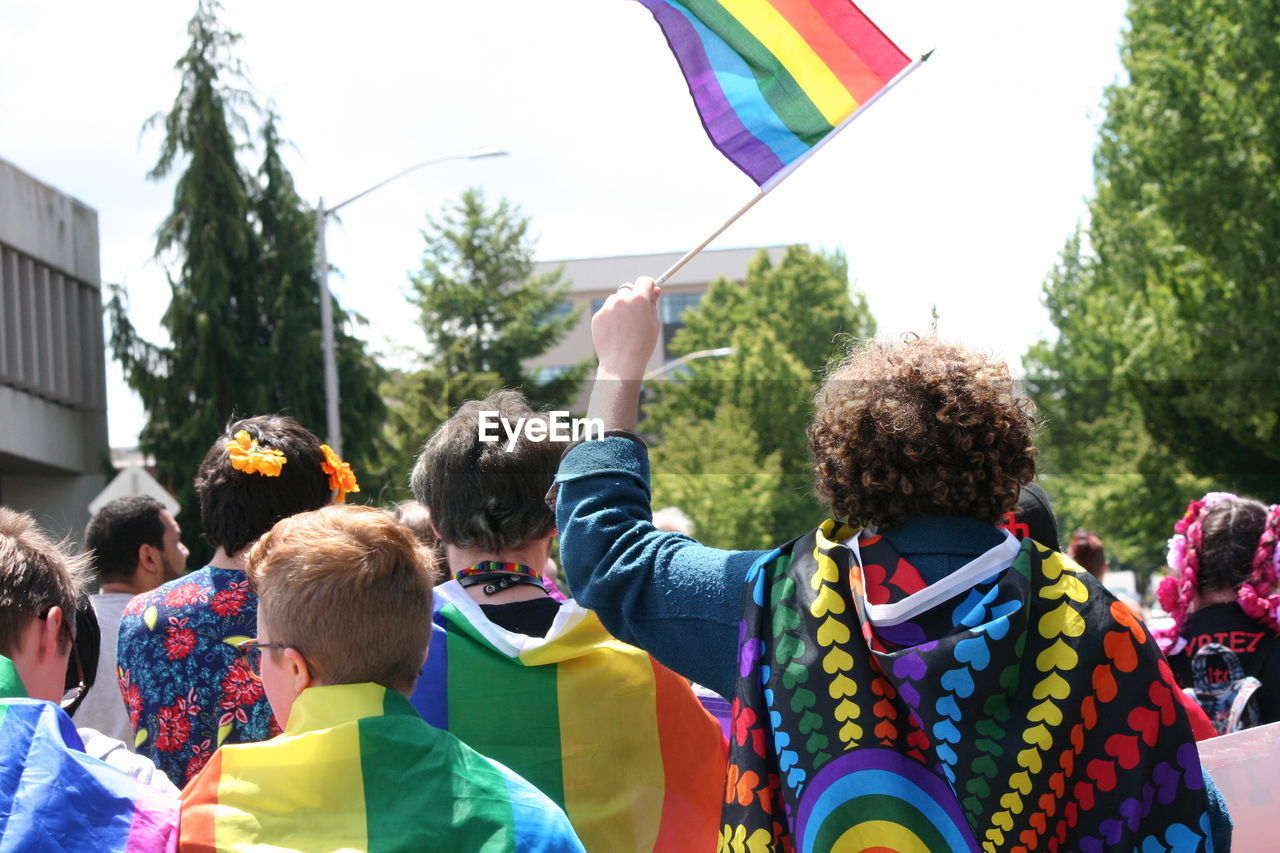 People walking with multi colored flags