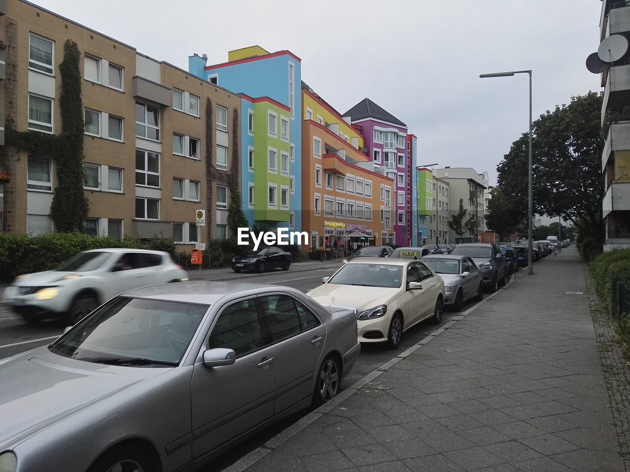 Cars parked along a narrow street