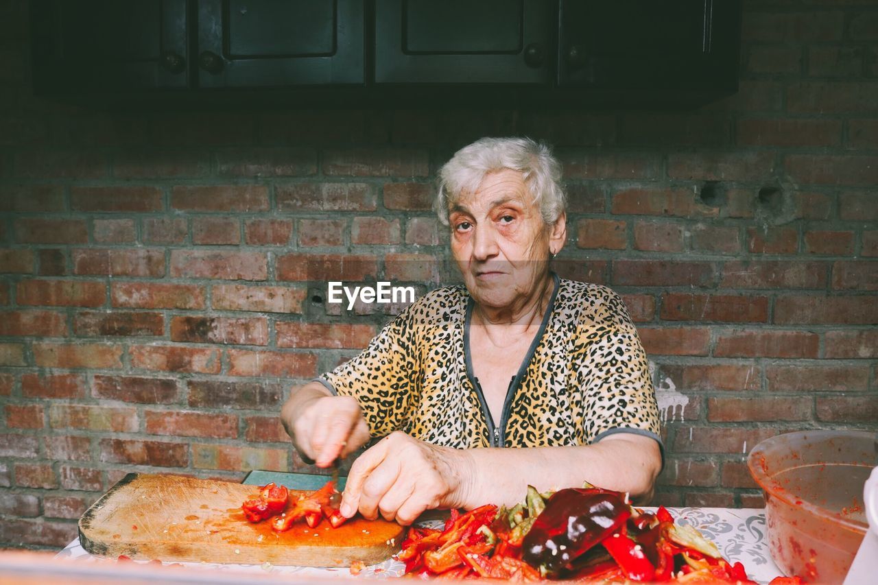 Portrait of senior woman preparing food