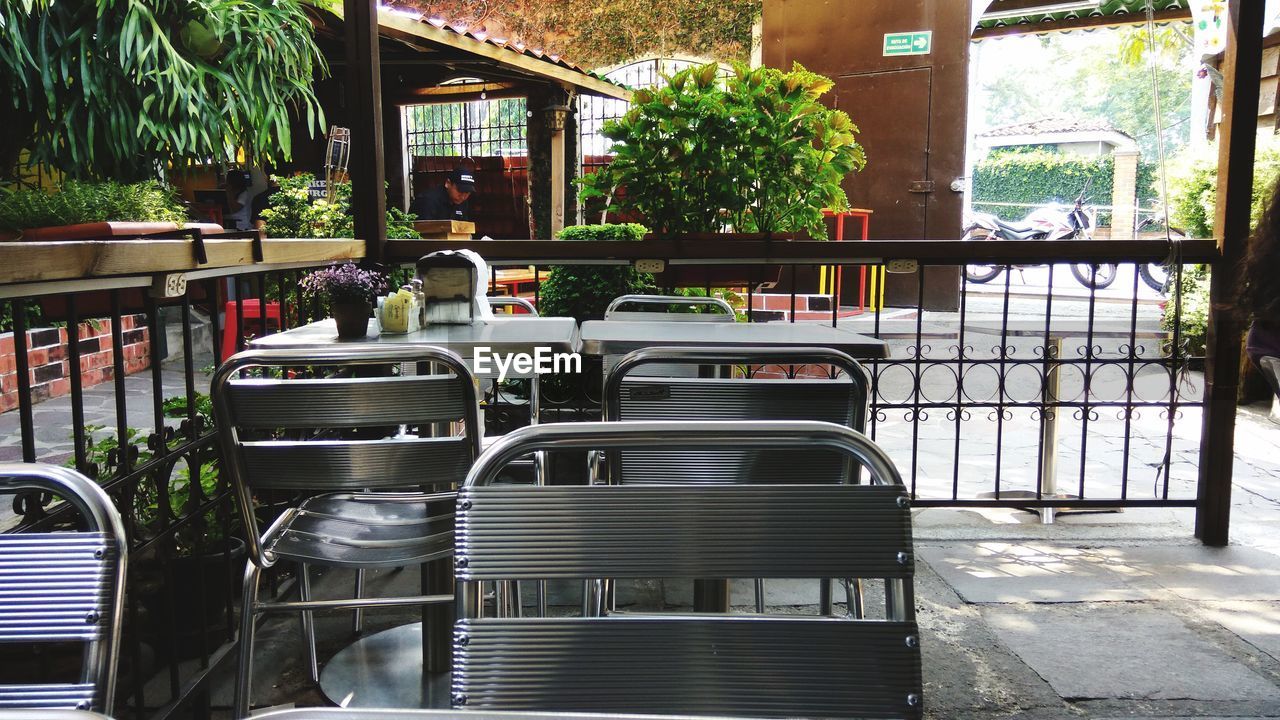 EMPTY CHAIRS AND TABLES IN RESTAURANT