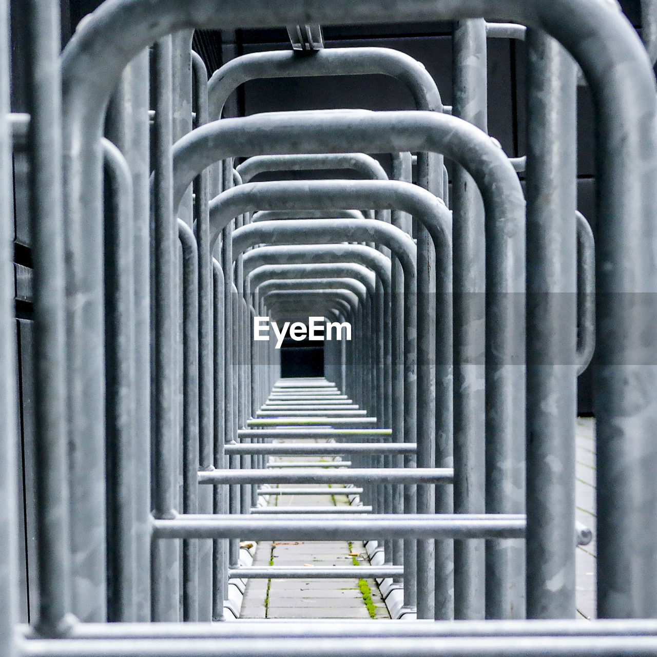 Close-up of metallic pipes on railing