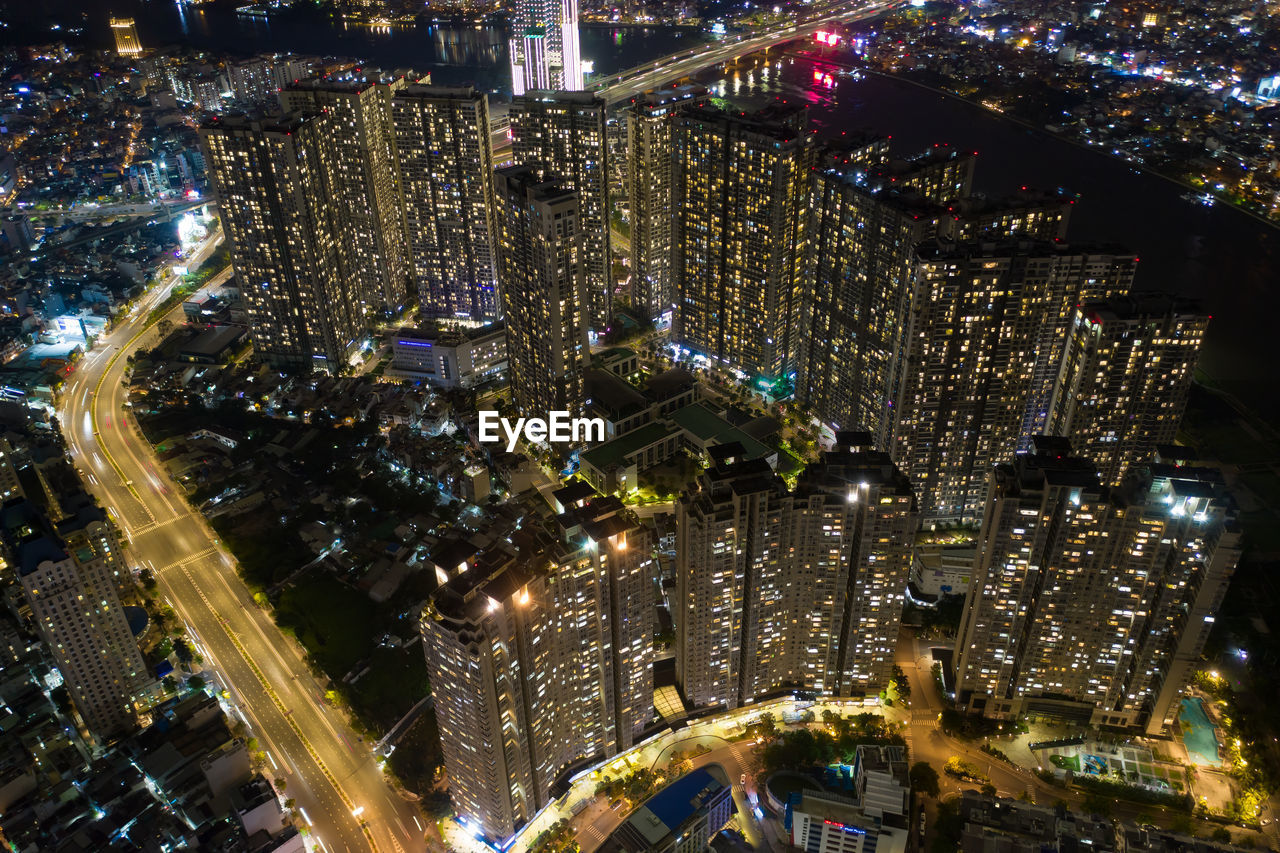 High angle view of city lit up at night