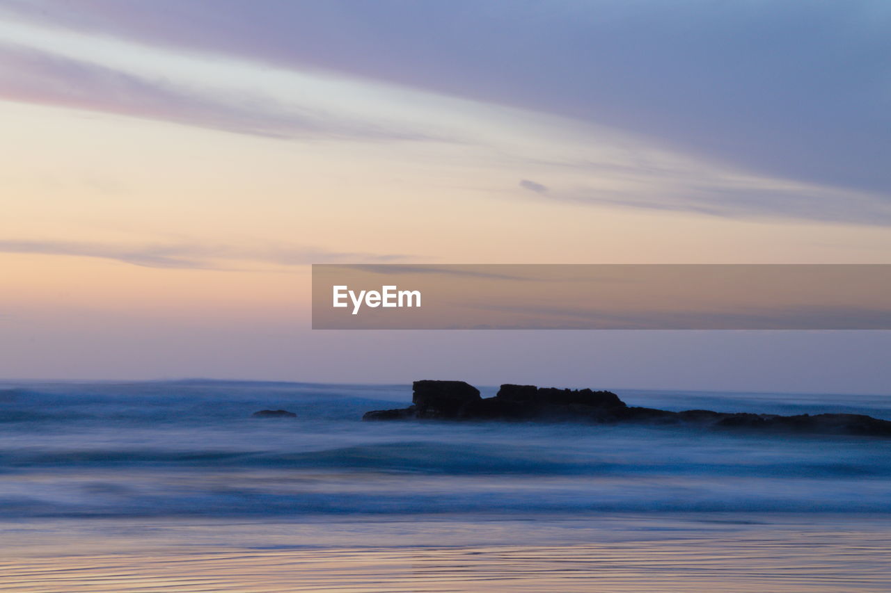 Scenic view of sea against sky at sunset