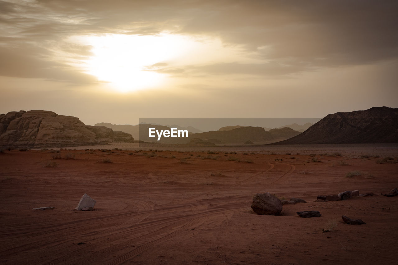 Scenic view of desert landscape against sky during sunset