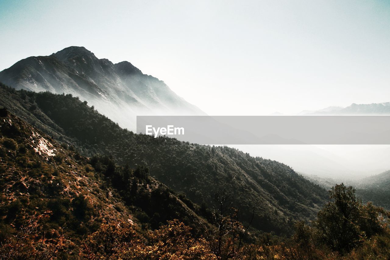 Scenic view of mountains against cloudy sky