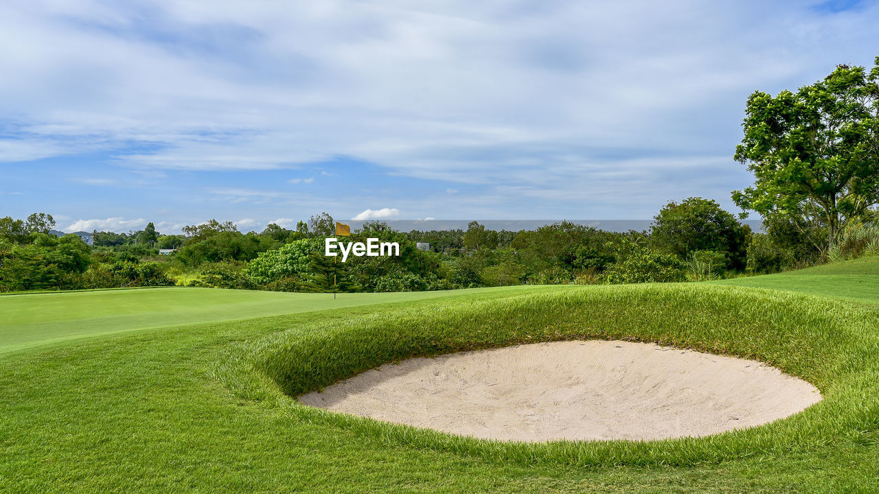 Scenic view of golf course against sky