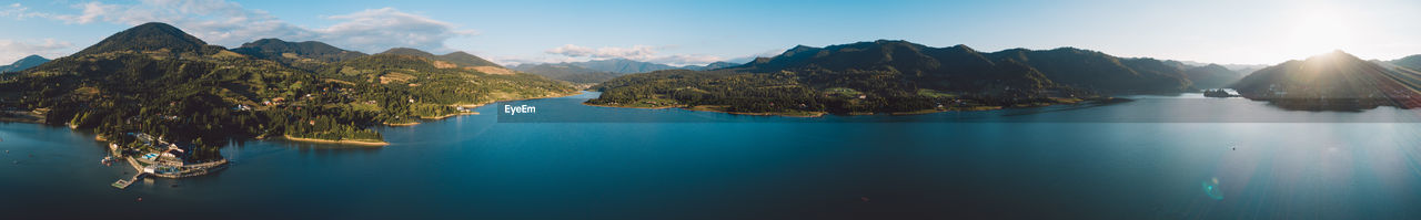 Panoramic view of sea and mountains against sky