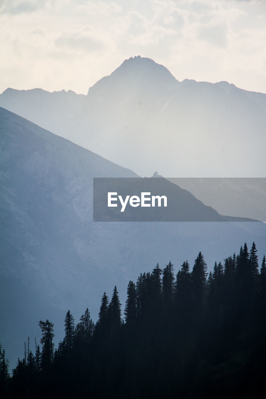 Scenic view of mountain against cloudy sky