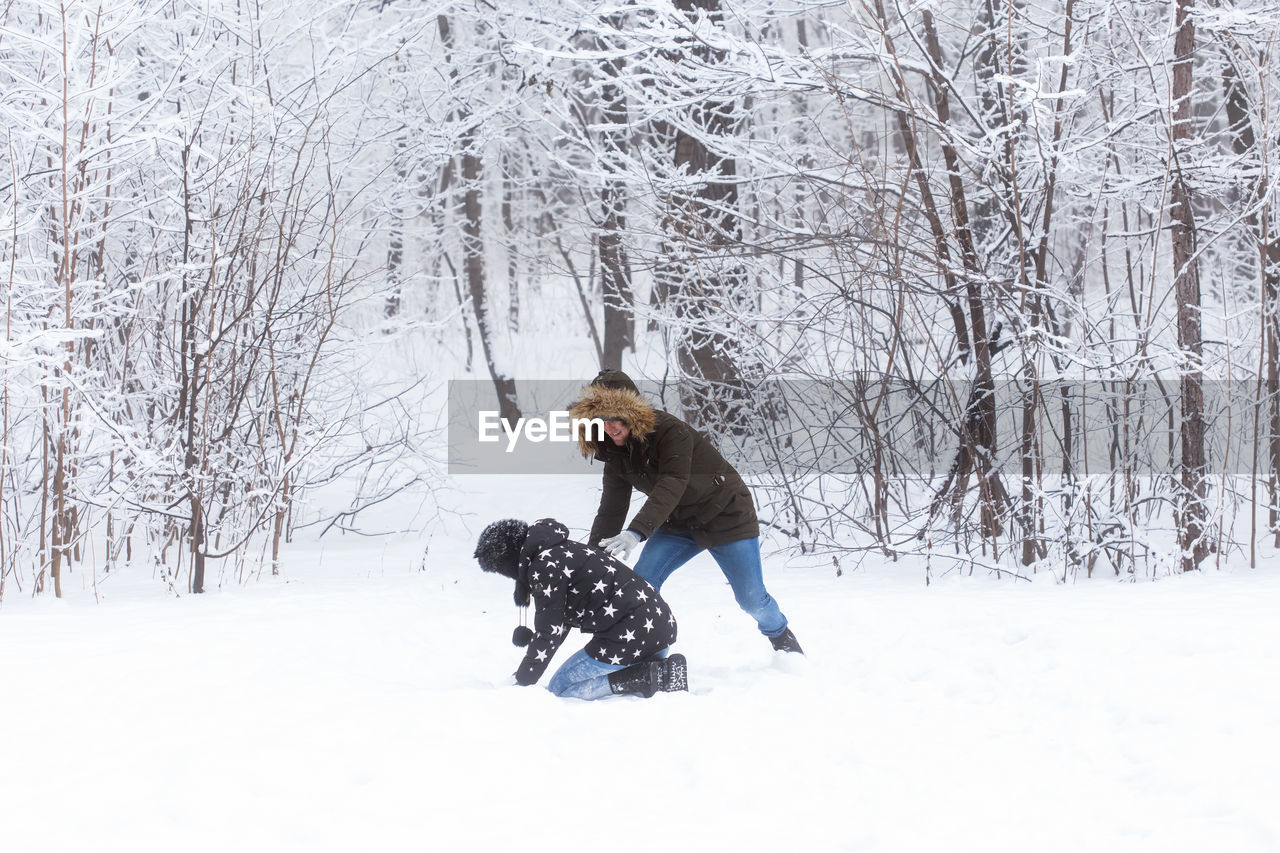 WOMAN WITH DOG ON SNOW