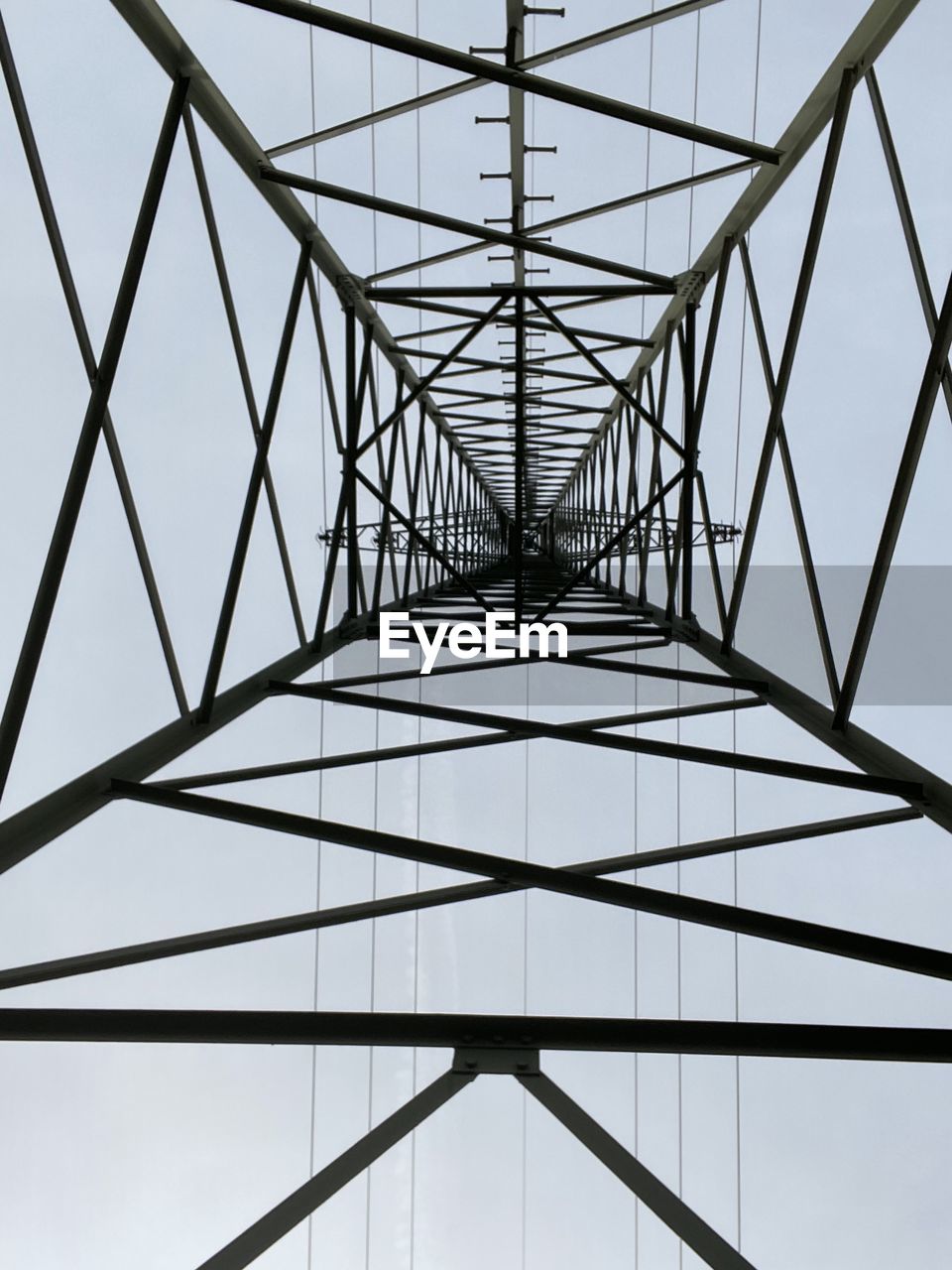 technology, electricity pylon, electricity, power supply, power generation, built structure, architecture, cable, line, sky, girder, pattern, no people, tower, communication, grid, abstract, outdoor structure, alloy, electrical grid, below, transmission tower, nature, steel, looking up, construction frame, silhouette, industry, high voltage sign, curve, arch, global communications, metal, concentric, power line, complexity, overhead power line, clear sky, sign, outdoors, cloud, hanging, warning sign, business finance and industry