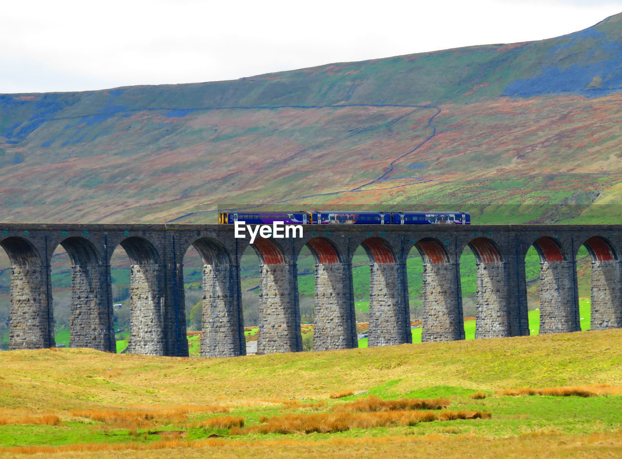 VIEW OF BRIDGE OVER MOUNTAINS