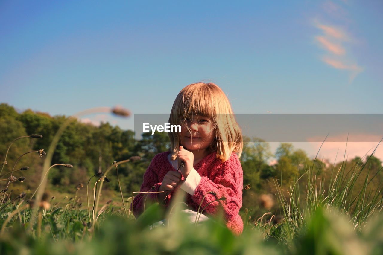 Girl on field against clear sky