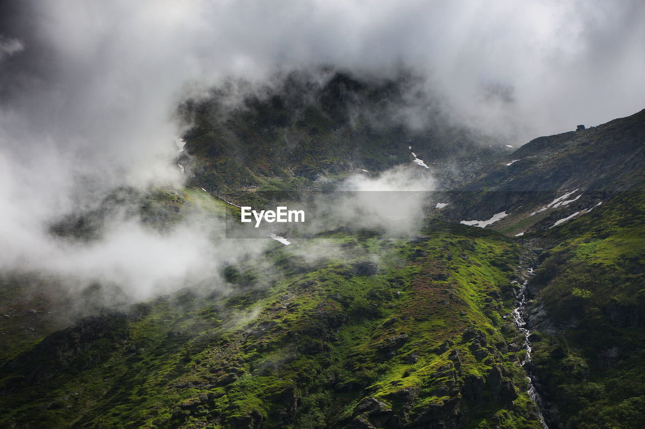 High angle view of mountains amidst fog