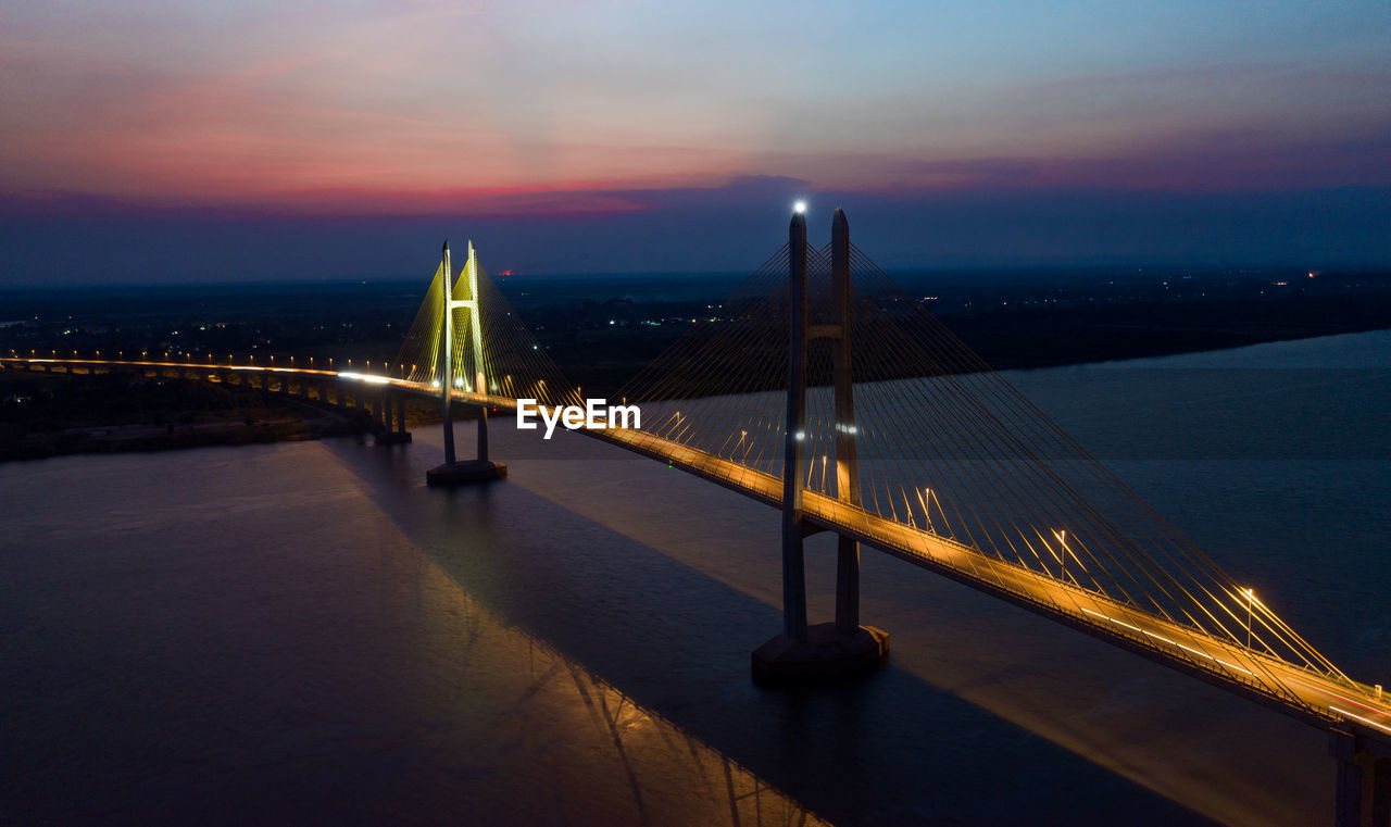 High angle view of illuminated bridge against sky during sunset