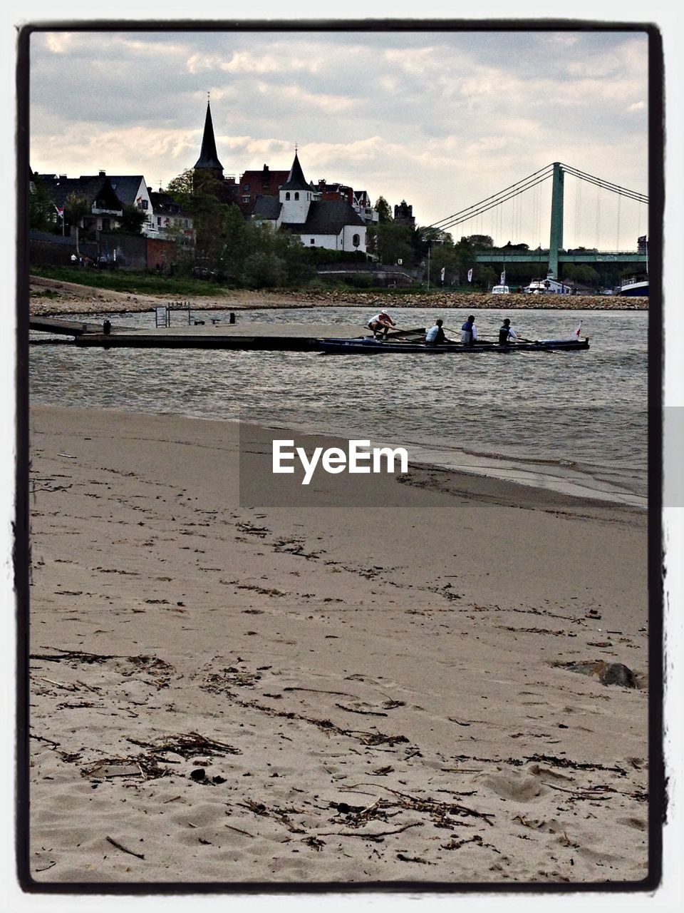 View of sandy beach and people in kayak