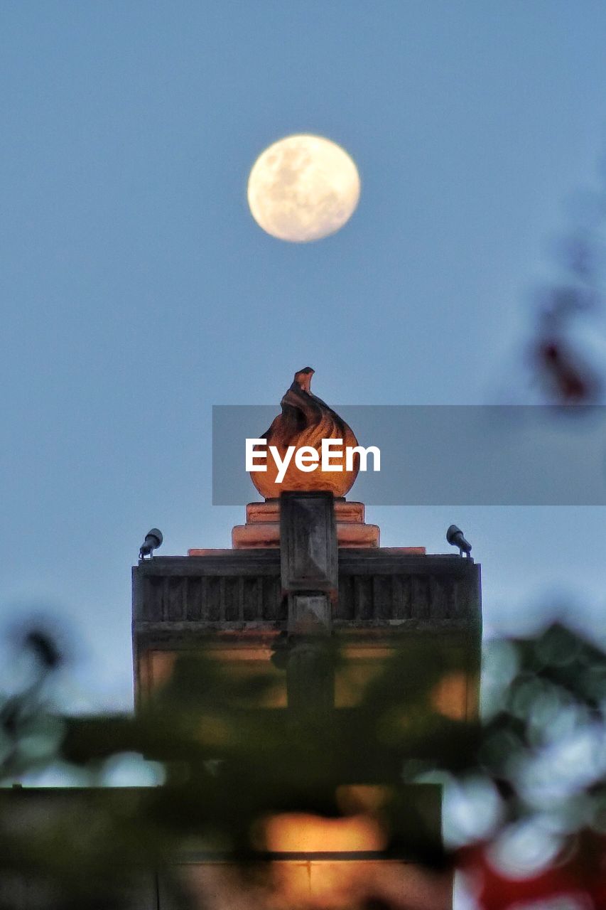 LOW ANGLE VIEW OF MOON AGAINST CLEAR SKY