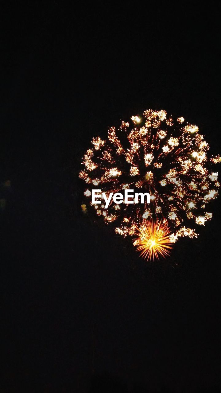 LOW ANGLE VIEW OF FIREWORKS EXPLODING AGAINST SKY