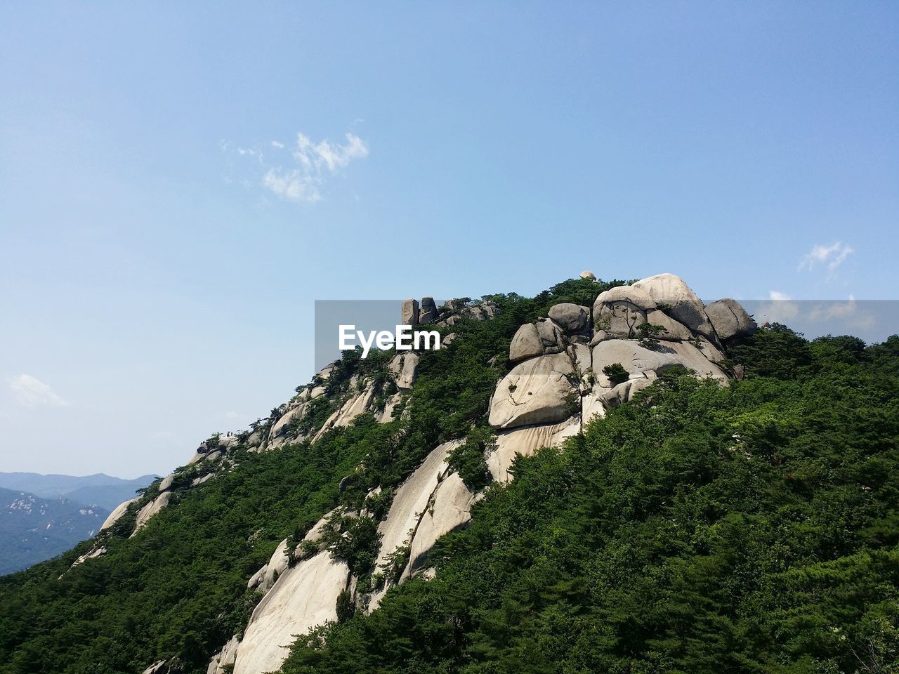 Low angle view of rocky mountain against sky