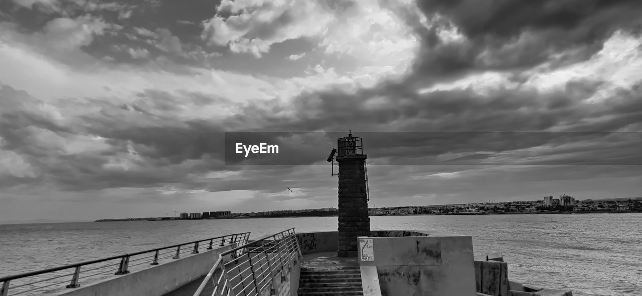 PANORAMIC VIEW OF PIER ON BEACH AGAINST SKY