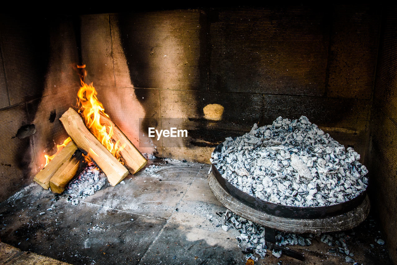 Burning firewood and coals in fireplace