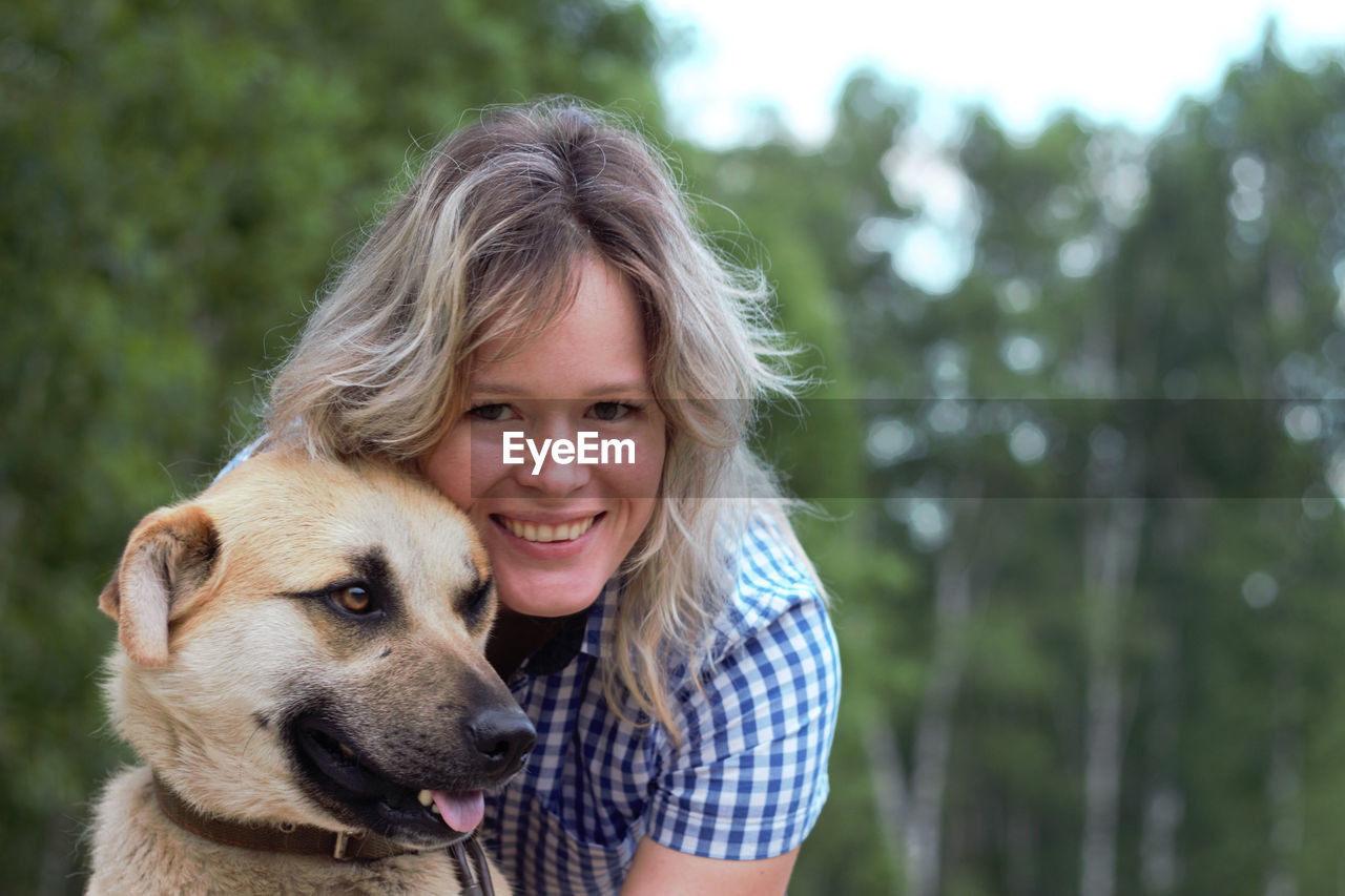 Portrait of young woman with dog