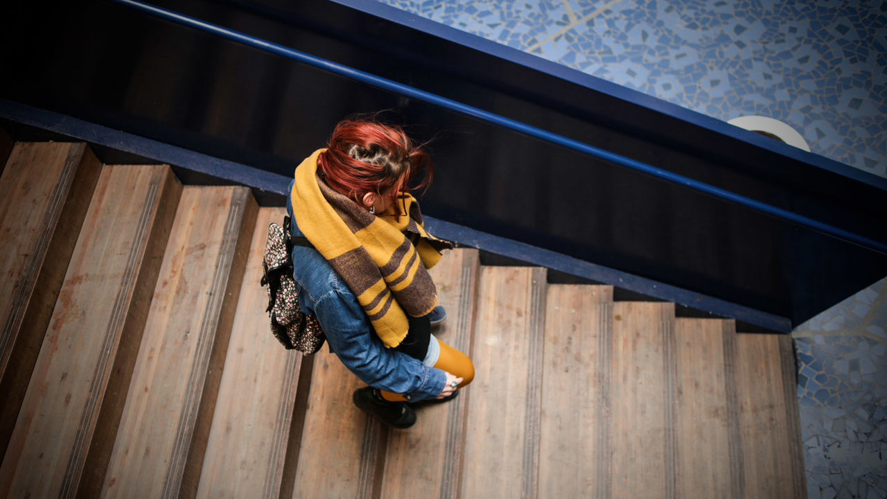 Full length of woman standing on wooden wall