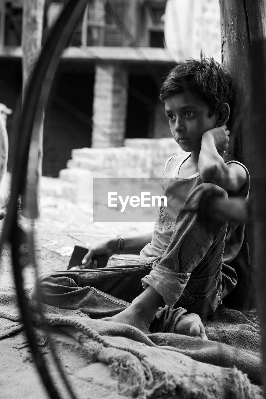 FULL LENGTH PORTRAIT OF BOY SITTING