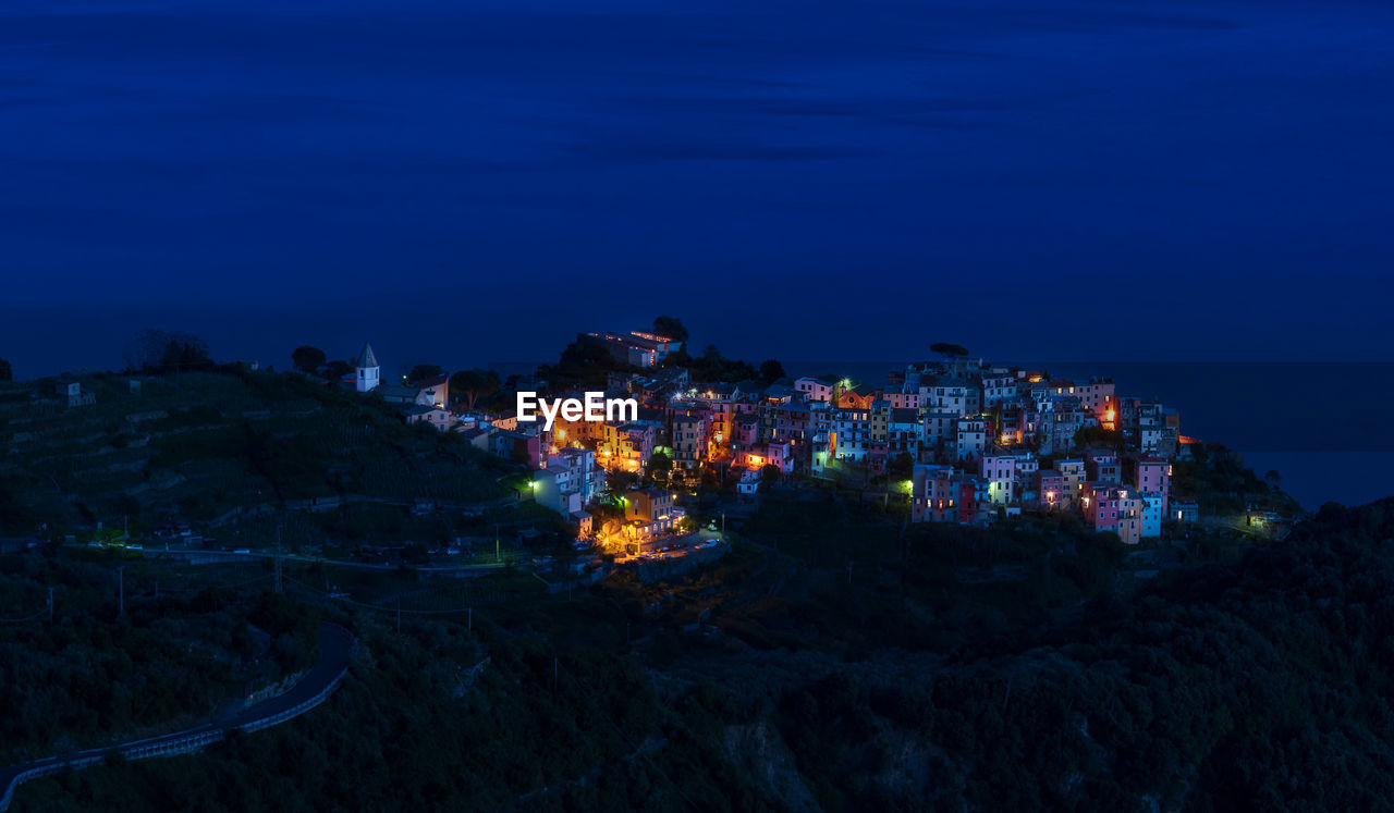 The village of corniglia in cinque terre, italy, illuminated at night turns it into a fairy tale