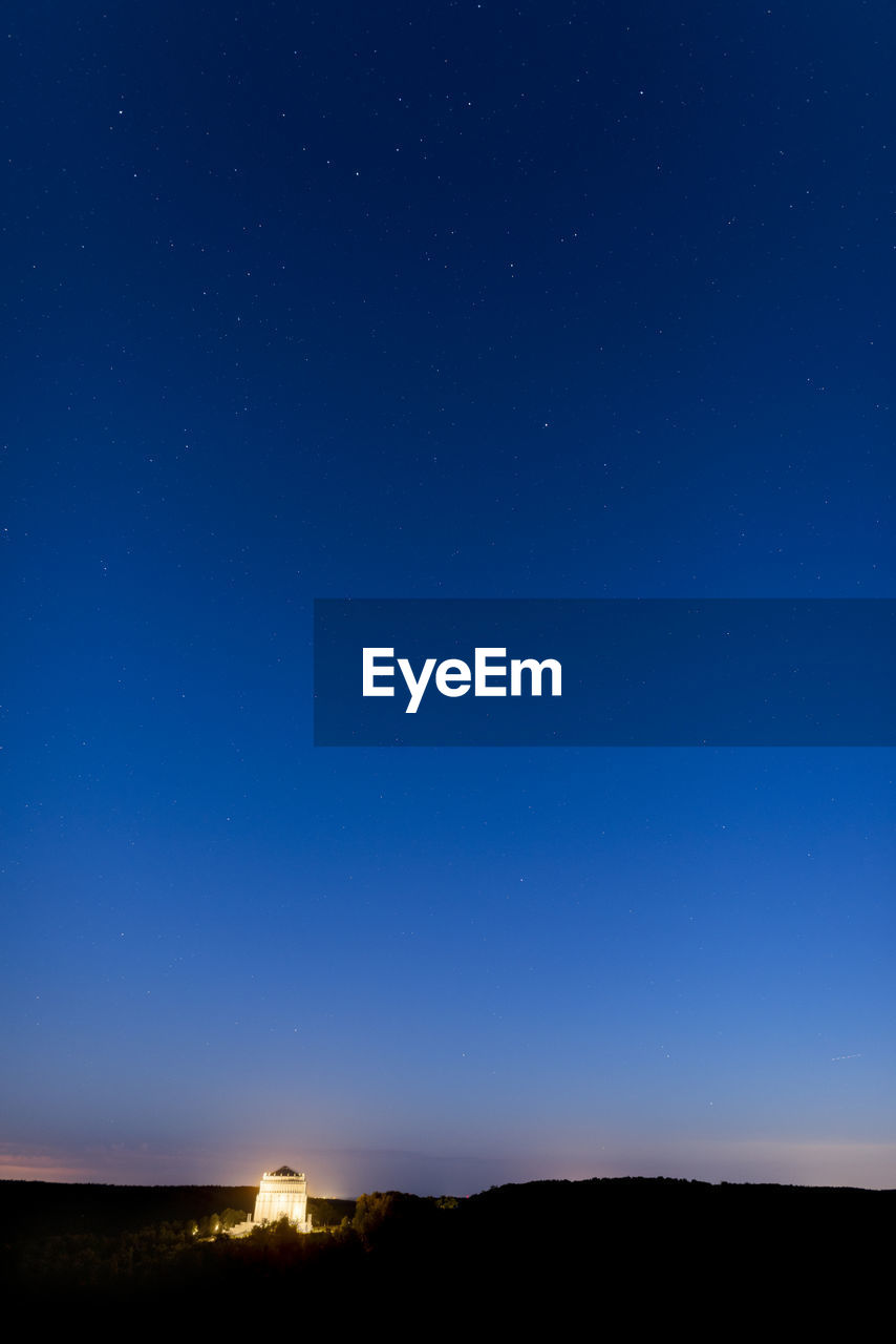 SILHOUETTE LANDSCAPE AGAINST CLEAR BLUE SKY