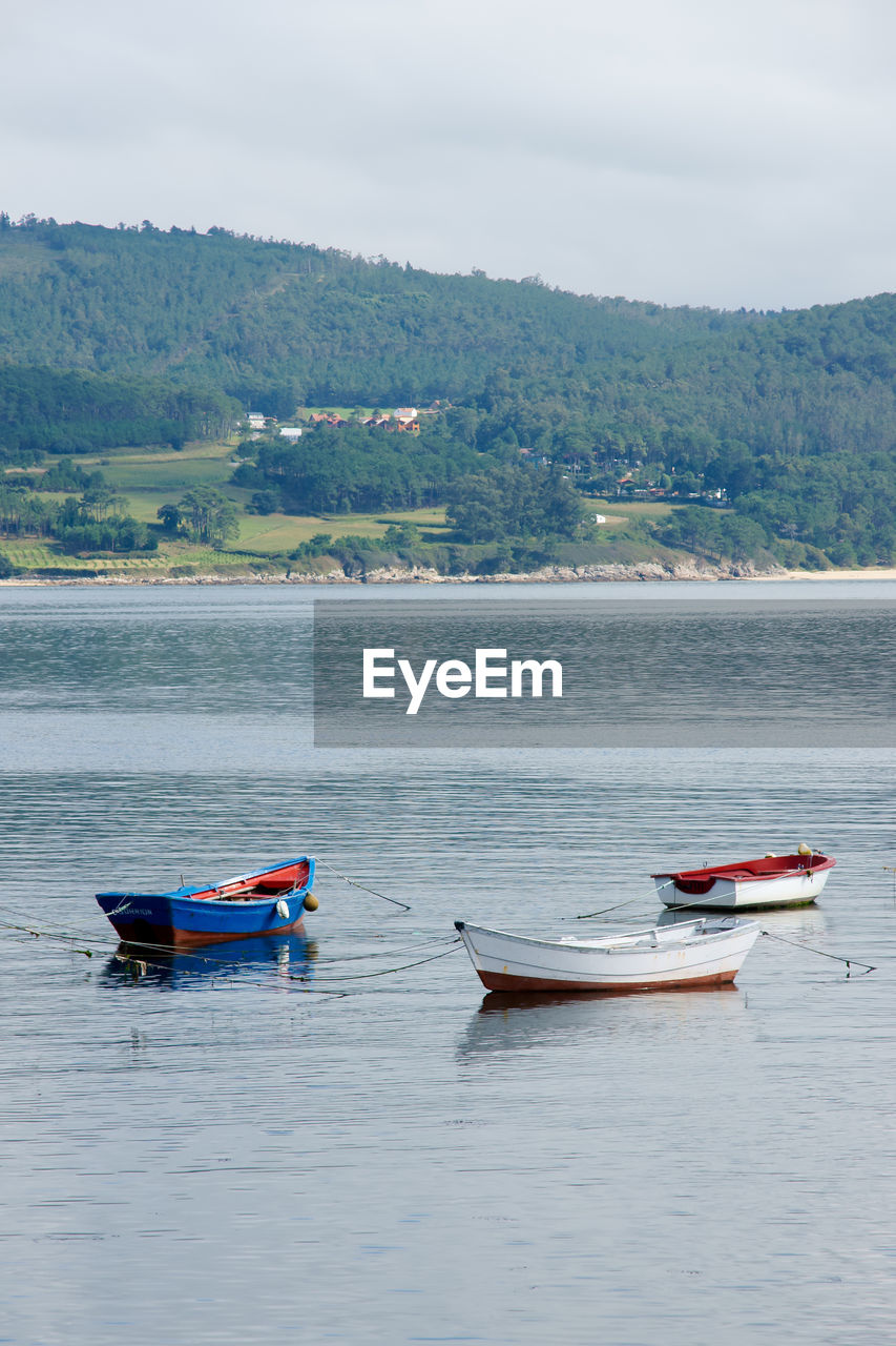 BOAT MOORED IN LAKE