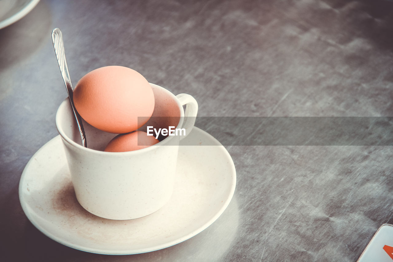 Close-up of eggs in cup on table