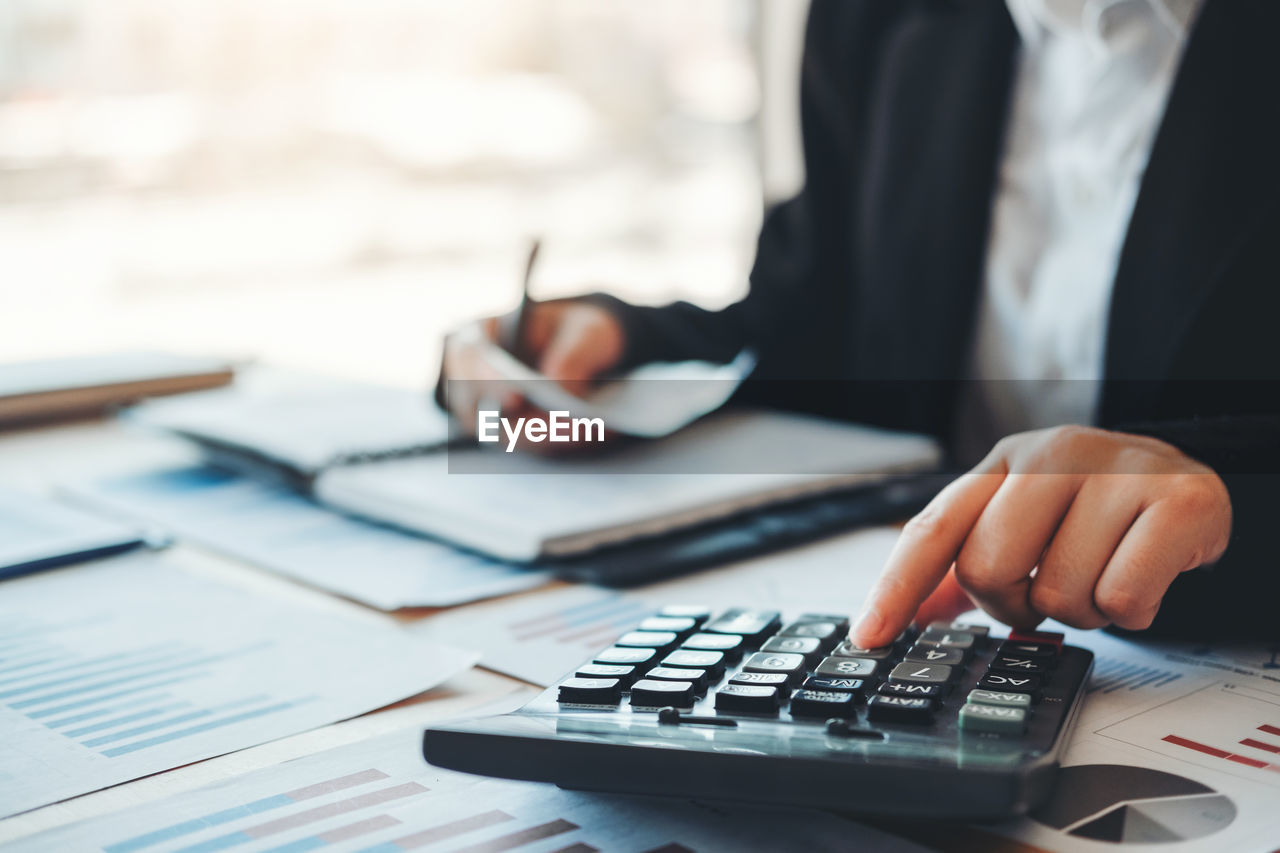 Midsection of business woman working in office