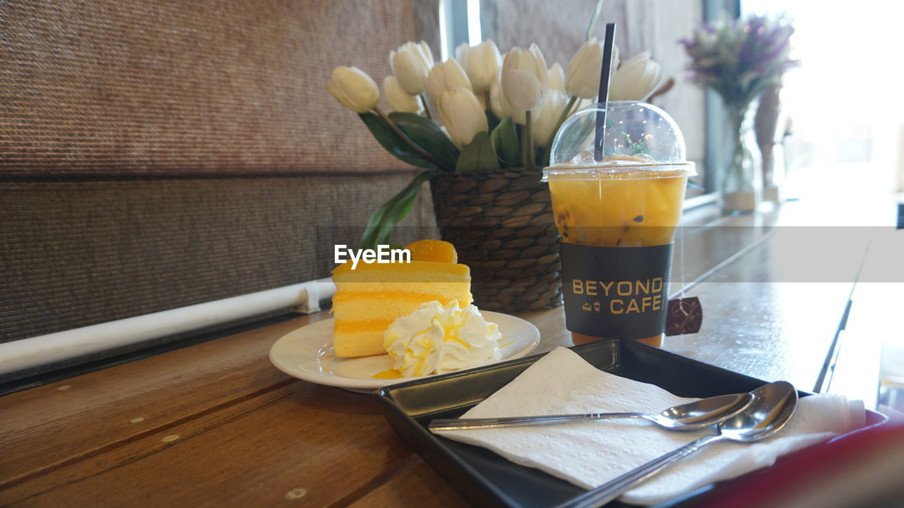 CLOSE-UP OF DRINK ON TABLE AT HOME